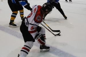 Ceptors' captain Jake Adamsons fights for the puck on Friday.