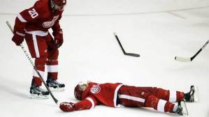 "Is he dead?" That's what Drew Miller appears to be wondering after Red Wing Patrick Eaves'  face met a puck. Eaves was out for a year. Would a face cage have helped?